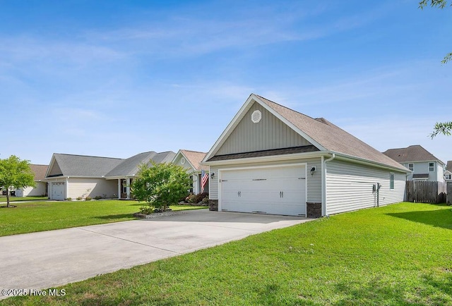 312 Hughes Ln, Jacksonville, NC 28546 - view of front facade with board and batten siding, driveway, and stone siding
