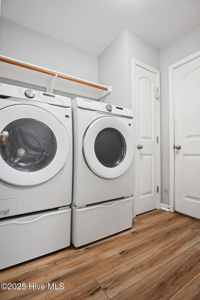 312 Hughes Ln, Jacksonville, NC 28546 - laundry area featuring washer and dryer and wood finished floors