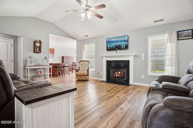 312 Hughes Ln, Jacksonville, NC 28546 - living area with a ceiling fan, lofted ceiling, light wood-style floors, healthy amount of natural light, and a fireplace with flush hearth