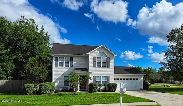 traditional home featuring driveway and a garage