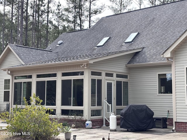 201 Shreveport Ct, Havelock, NC 28532 - back of property with a sunroom and roof with shingles