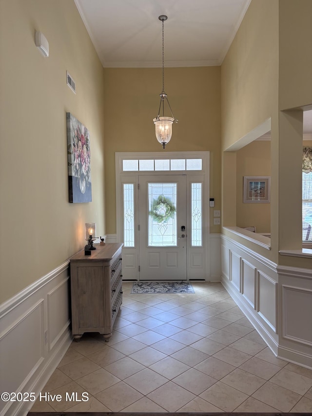 201 Shreveport Ct, Havelock, NC 28532 - foyer featuring a decorative wall, healthy amount of natural light, light tile patterned floors, a towering ceiling, and crown molding