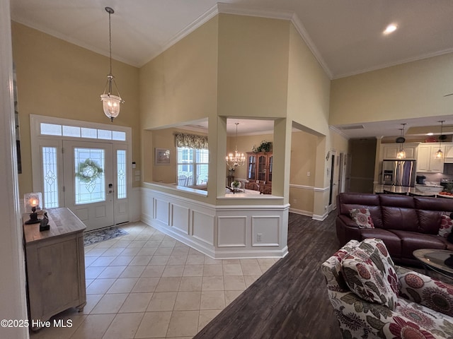 201 Shreveport Ct, Havelock, NC 28532 - entryway with a high ceiling, a chandelier, crown molding, wainscoting, and recessed lighting