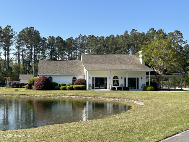 201 Shreveport Ct, Havelock, NC 28532 - view of front of home with a front yard, a water view, a chimney, and a carport