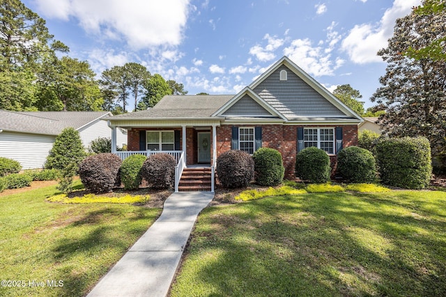 903 Buckingham Rd, Trent Woods, NC 28562 - view of front of home featuring brick siding, covered porch, and a front lawn