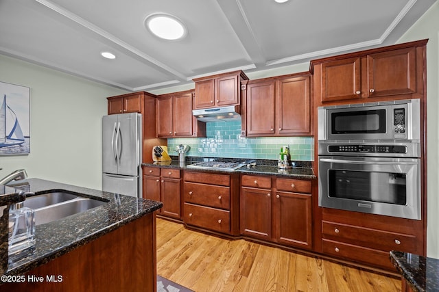 903 Buckingham Rd, Trent Woods, NC 28562 - kitchen featuring appliances with stainless steel finishes, a sink, under cabinet range hood, light wood finished floors, and dark stone countertops