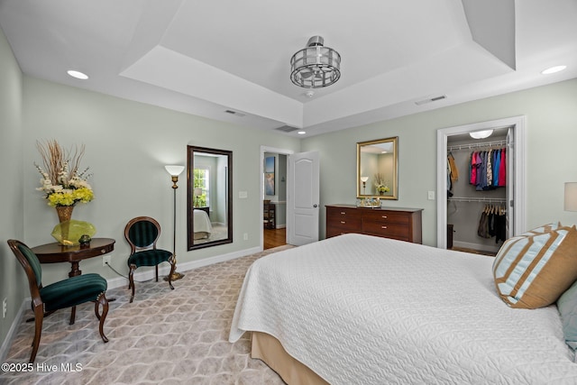 903 Buckingham Rd, Trent Woods, NC 28562 - bedroom with a tray ceiling, baseboards, a spacious closet, recessed lighting, and light carpet