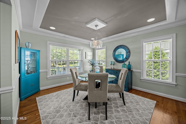903 Buckingham Rd, Trent Woods, NC 28562 - dining room with a raised ceiling, wood finished floors, crown molding, a chandelier, and baseboards