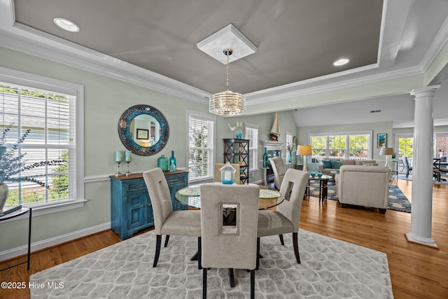 903 Buckingham Rd, Trent Woods, NC 28562 - dining space with a raised ceiling, decorative columns, plenty of natural light, crown molding, and a chandelier