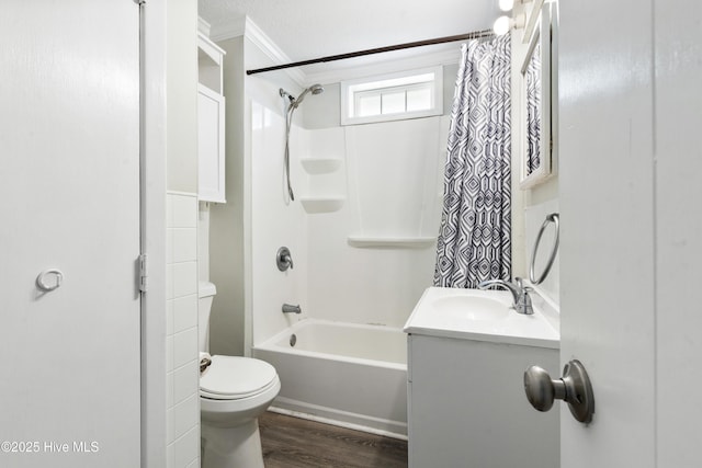 bathroom featuring toilet, wood finished floors, crown molding, vanity, and shower / bathtub combination with curtain