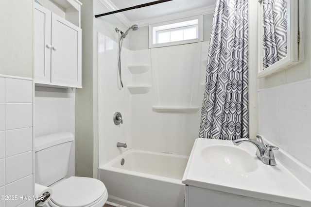 bathroom featuring toilet, shower / bath combo with shower curtain, ornamental molding, and vanity