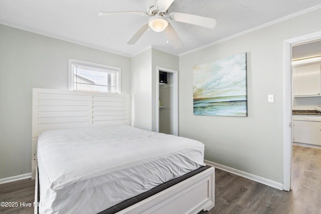bedroom with dark wood-style floors, crown molding, a closet, and baseboards