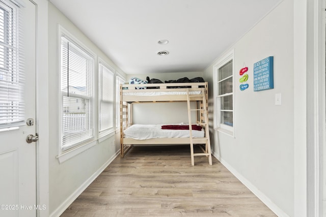 bedroom with wood finished floors and baseboards