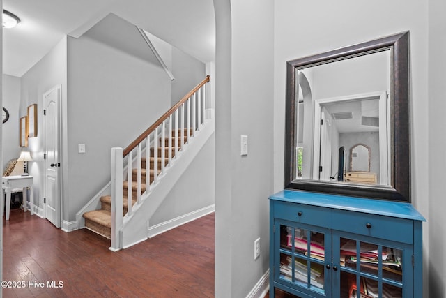 stairs with wood finished floors and baseboards