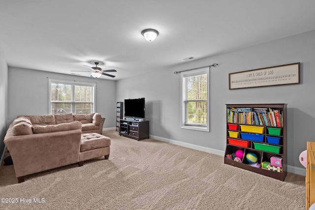 living room with carpet floors, healthy amount of natural light, and baseboards