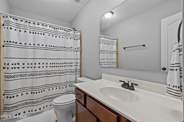 full bathroom with toilet, vanity, and a shower with curtain