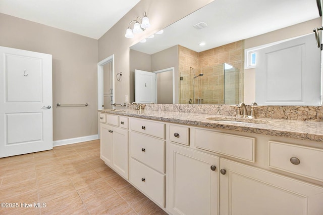 3524 Laughing Gull Ter, Wilmington, NC 28412 - full bathroom featuring a stall shower, double vanity, baseboards, and tile patterned floors