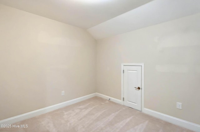 3524 Laughing Gull Ter, Wilmington, NC 28412 - spare room with baseboards, light carpet, and vaulted ceiling