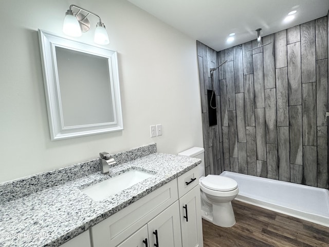 200 Colonial Ave, Clinton, NC 28328 - bathroom with vanity, a tile shower, wood finished floors, and recessed lighting