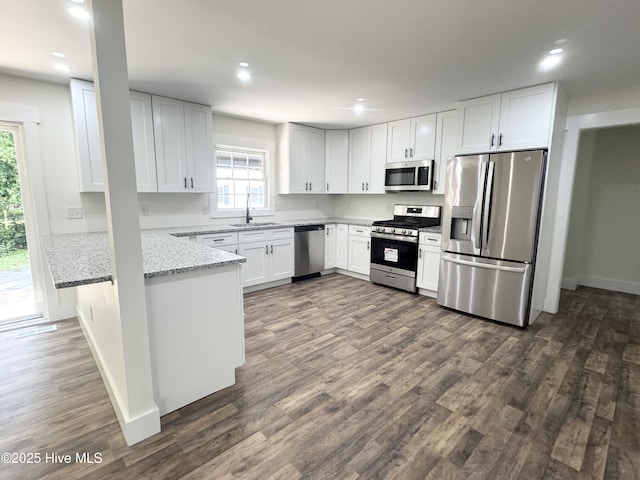 200 Colonial Ave, Clinton, NC 28328 - kitchen with appliances with stainless steel finishes, light stone countertops, dark wood finished floors, white cabinets, and recessed lighting