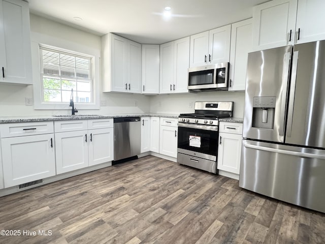 200 Colonial Ave, Clinton, NC 28328 - kitchen with appliances with stainless steel finishes, wood finished floors, white cabinets, and recessed lighting