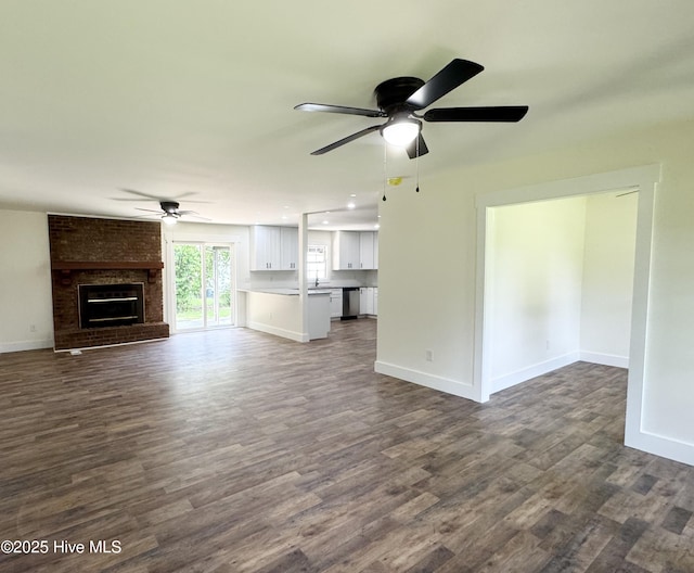 200 Colonial Ave, Clinton, NC 28328 - unfurnished living room featuring a ceiling fan, dark wood-type flooring, and a fireplace