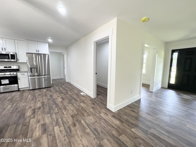 200 Colonial Ave, Clinton, NC 28328 - kitchen featuring appliances with stainless steel finishes, dark wood finished floors, white cabinetry, recessed lighting, and open floor plan