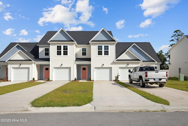 view of property featuring board and batten siding, concrete driveway, and a shingled roof