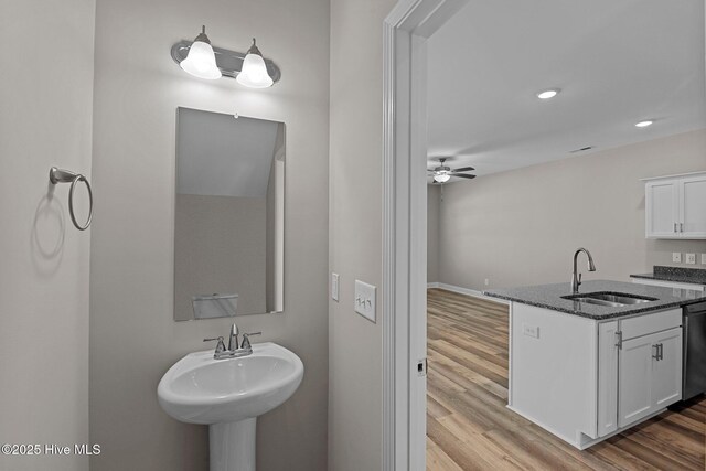 bathroom featuring a sink, wood finished floors, recessed lighting, and ceiling fan