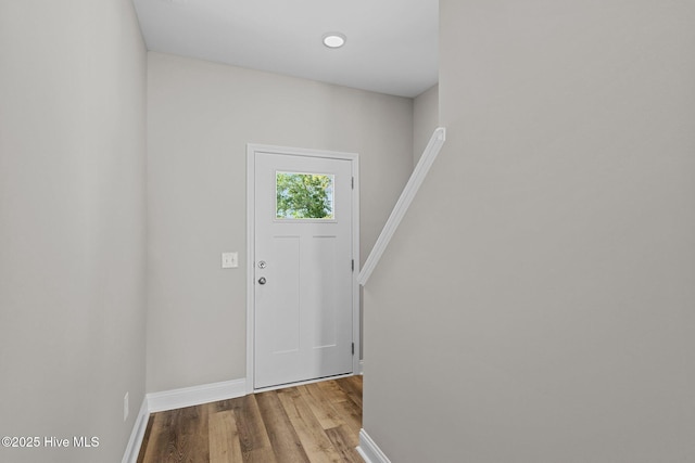 entrance foyer featuring baseboards and wood finished floors