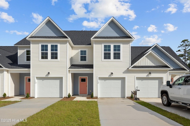 townhome / multi-family property with concrete driveway, board and batten siding, roof with shingles, and an attached garage