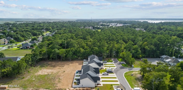 aerial view of residential area featuring a heavily wooded area