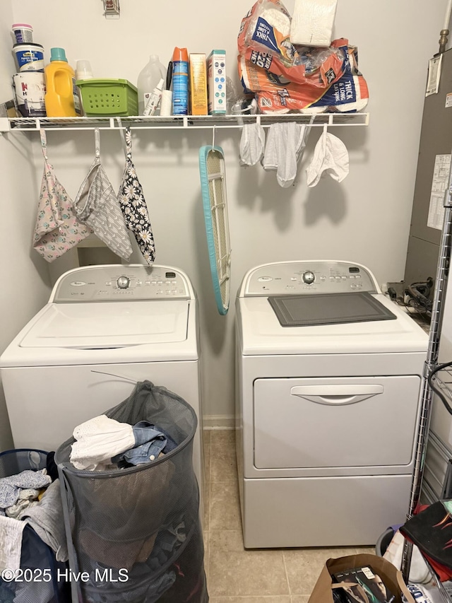 clothes washing area with separate washer and dryer and light tile patterned flooring