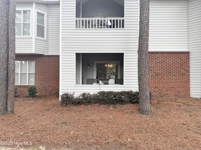 view of property exterior featuring brick siding