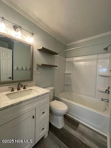 full bathroom with crown molding, shower / bathtub combination, toilet, and vanity