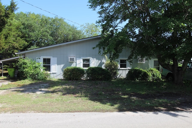 view of side of home with a yard