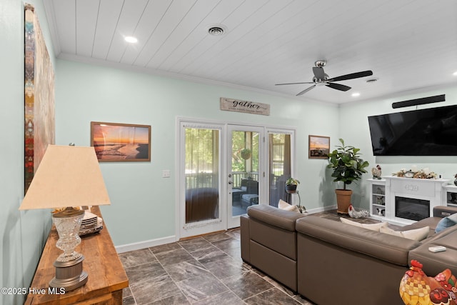 212 Park Ave, Southport, NC 28461 - living room featuring baseboards, recessed lighting, ceiling fan, a glass covered fireplace, and crown molding