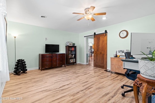 212 Park Ave, Southport, NC 28461 - office featuring light wood-type flooring, a barn door, ceiling fan, and baseboards
