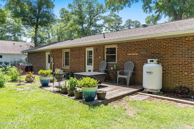 212 Park Ave, Southport, NC 28461 - rear view of property with a lawn, brick siding, and a wooden deck