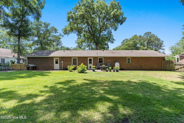 212 Park Ave, Southport, NC 28461 - rear view of property with brick siding and a patio area
