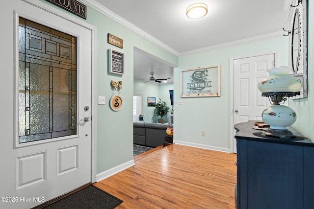 212 Park Ave, Southport, NC 28461 - entryway featuring ornamental molding, wood finished floors, and baseboards