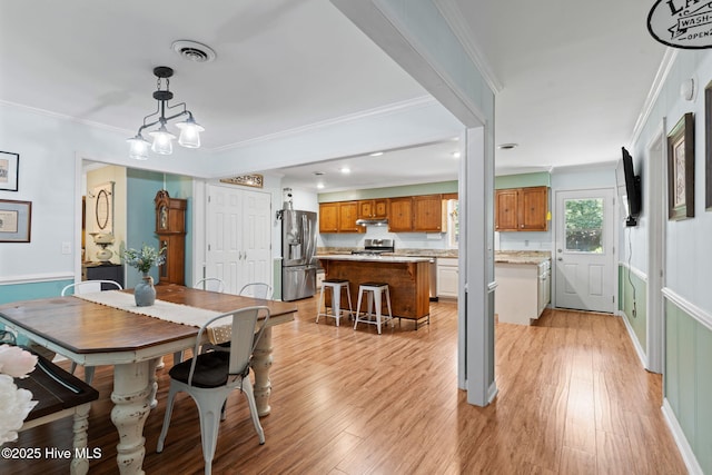 212 Park Ave, Southport, NC 28461 - dining area with light wood finished floors, ornamental molding, and recessed lighting