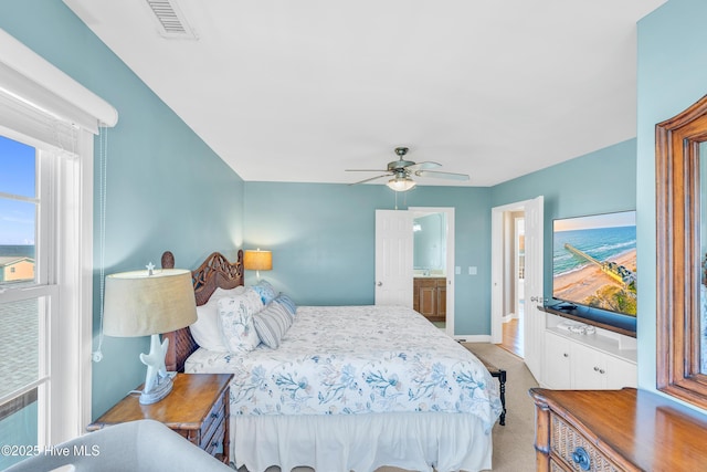 308 E Beach Dr, Oak Island, NC 28465 - bedroom with baseboards, light colored carpet, and ceiling fan