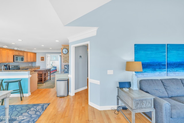 308 E Beach Dr, Oak Island, NC 28465 - living area featuring crown molding, baseboards, light wood-style floors, and recessed lighting