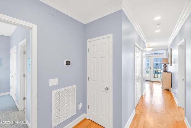 308 E Beach Dr, Oak Island, NC 28465 - hallway featuring light wood-type flooring, crown molding, and baseboards