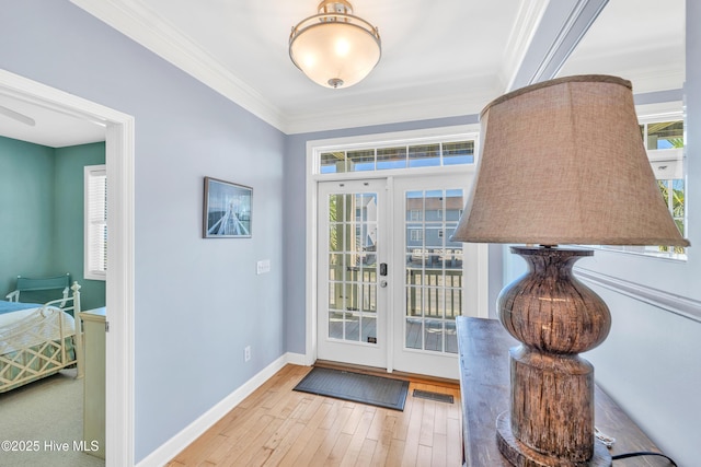 308 E Beach Dr, Oak Island, NC 28465 - doorway featuring wood-type flooring, ornamental molding, and baseboards