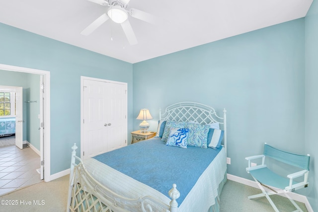 308 E Beach Dr, Oak Island, NC 28465 - carpeted bedroom with baseboards, a closet, a ceiling fan, and tile patterned floors