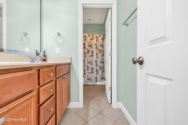 308 E Beach Dr, Oak Island, NC 28465 - bathroom featuring tile patterned flooring, vanity, curtained shower, and baseboards