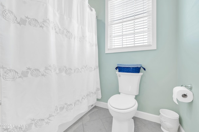 308 E Beach Dr, Oak Island, NC 28465 - full bath with toilet, tile patterned flooring, baseboards, and a shower with curtain