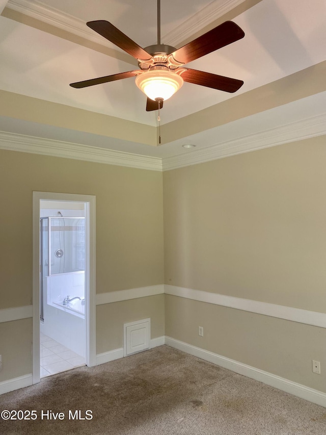 unfurnished room with light colored carpet, crown molding, ceiling fan, and baseboards